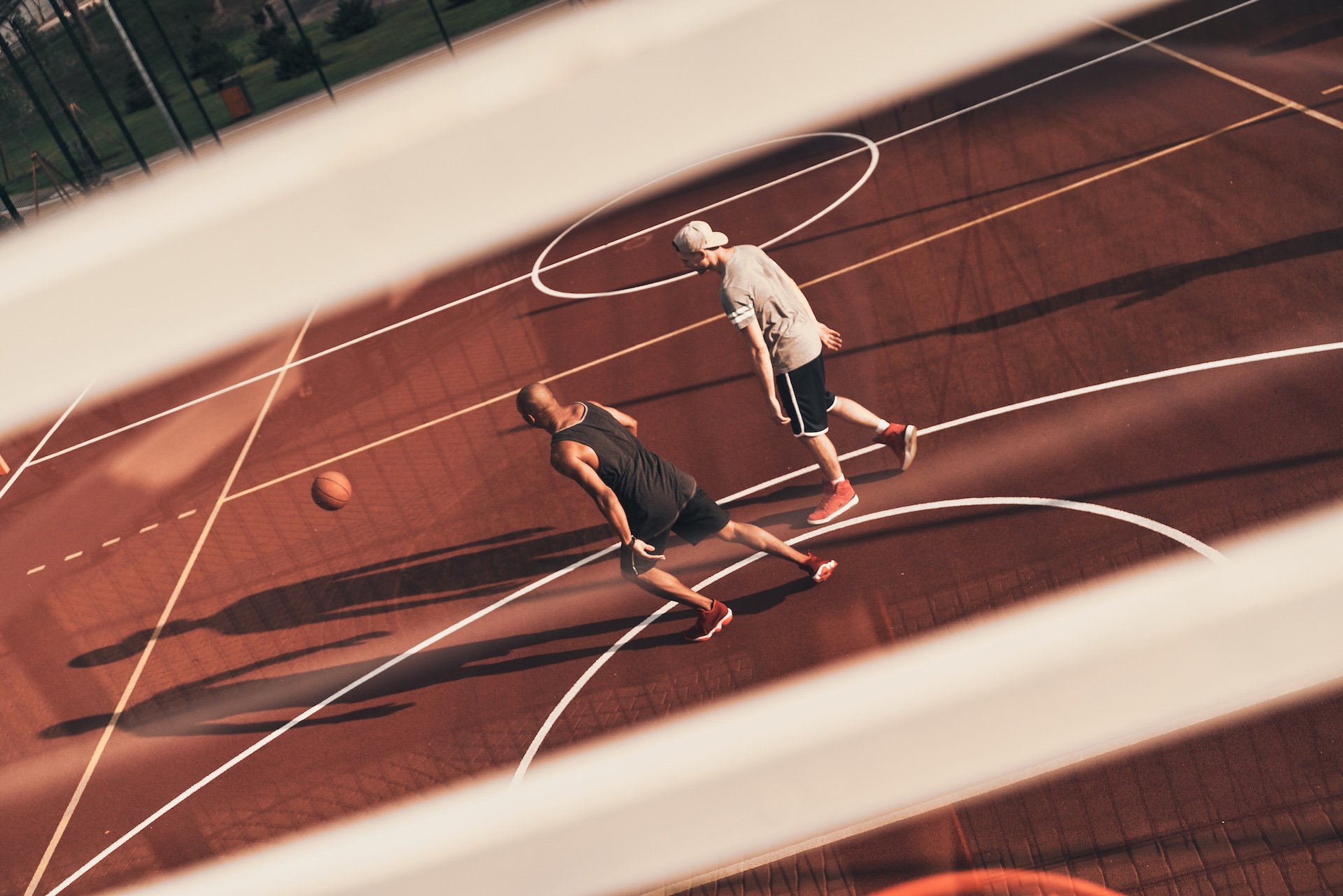 Here to compete. Top view of young men in sports clothing playing basketball while spending time outdoors